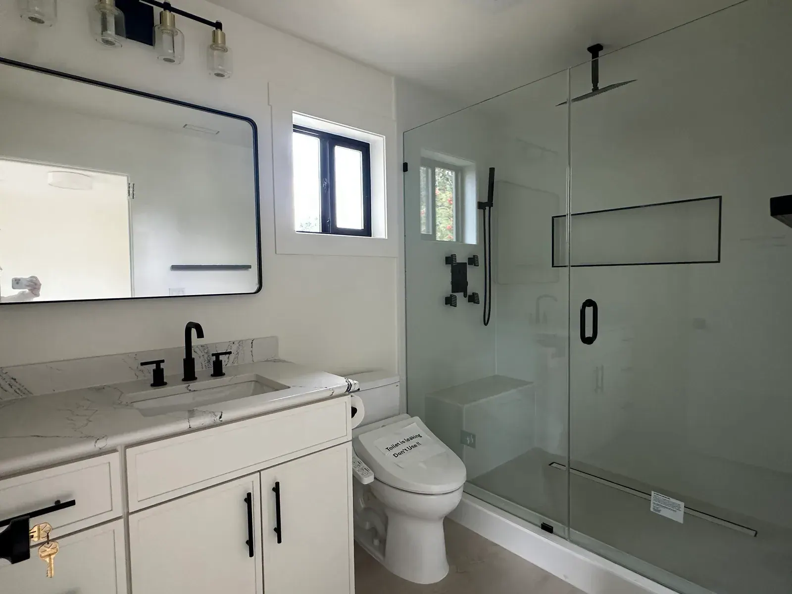 Finished Redmond bathroom remodel with a glass shower enclosure, freestanding tub, and custom vanity