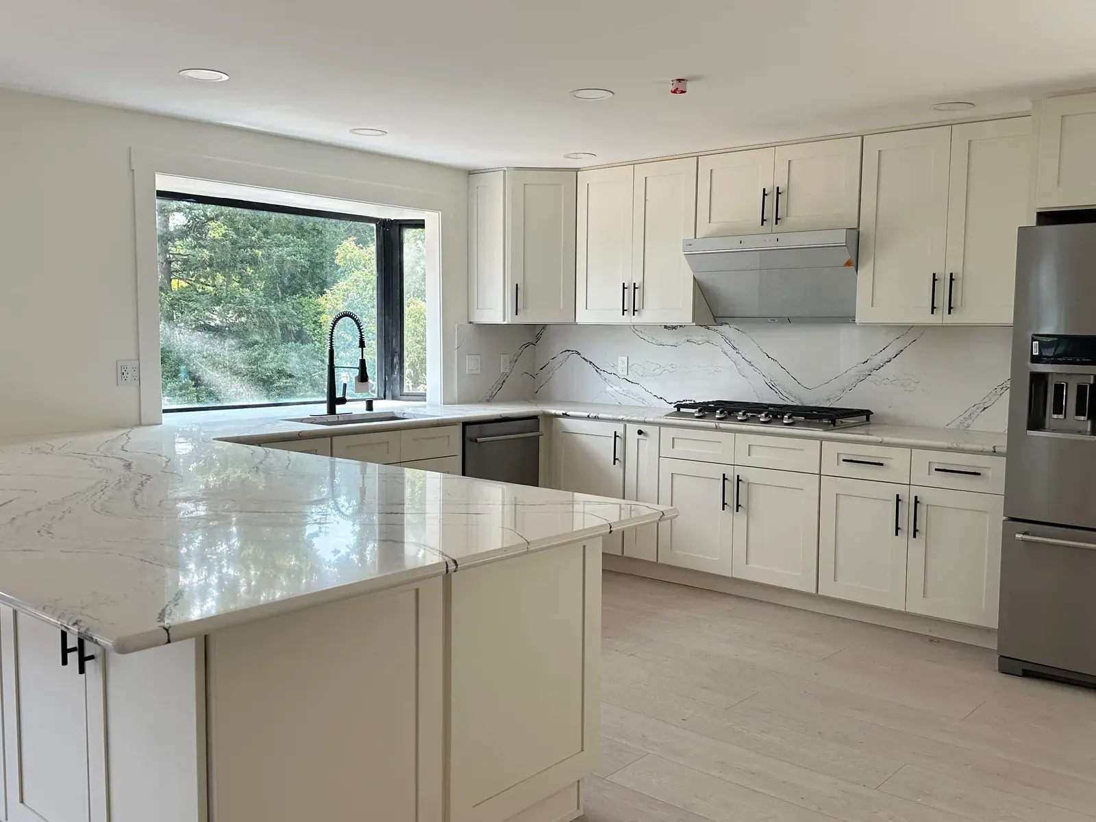 Finished Redmond kitchen remodel with warm cabinetry, a large island, and generous work surfaces